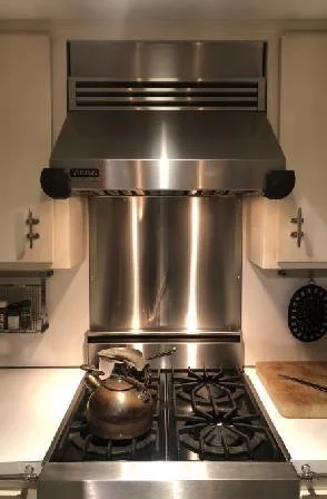The stainless steel backsplash is installed at the cooking counter